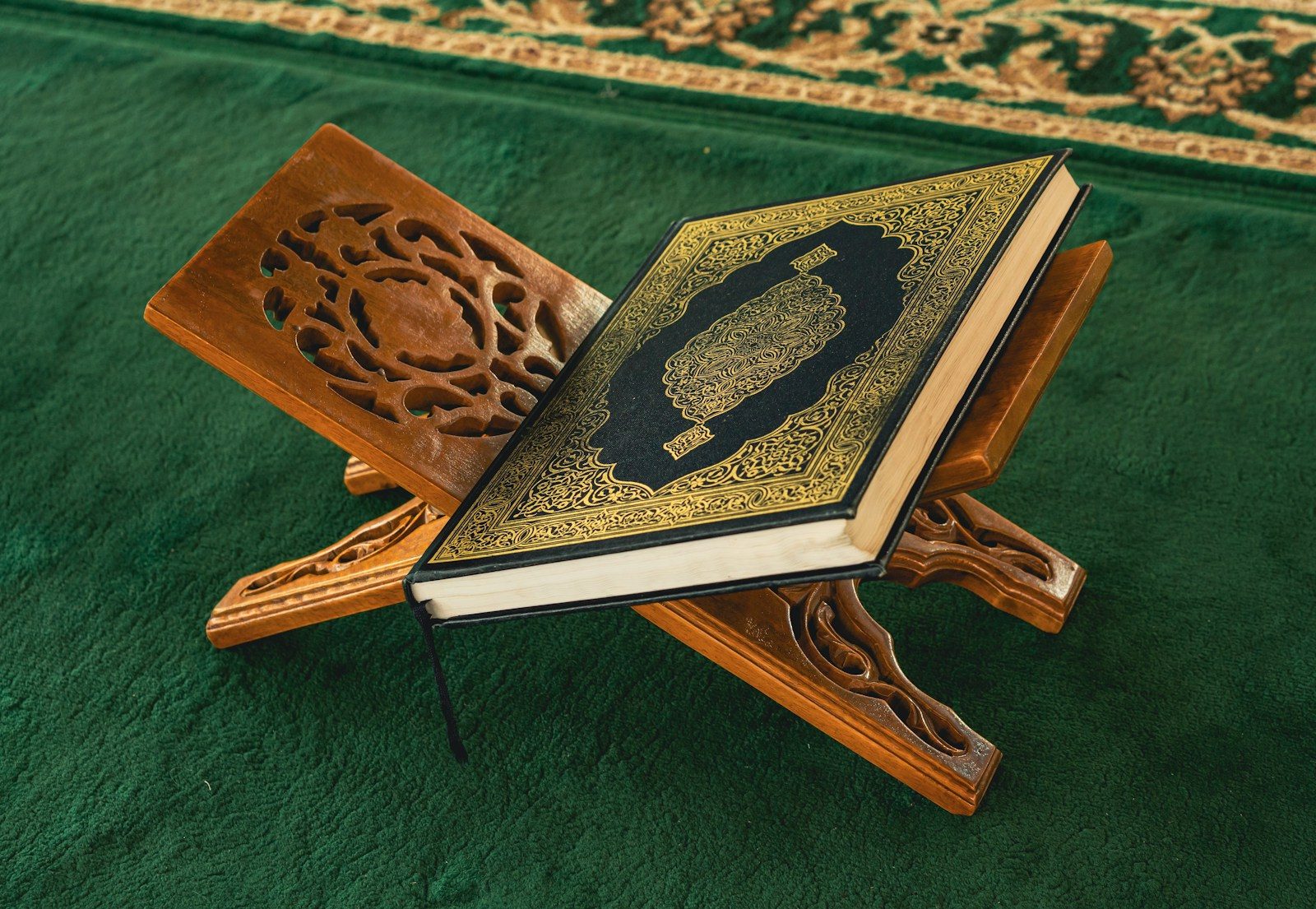 An open book sitting on top of a wooden stand